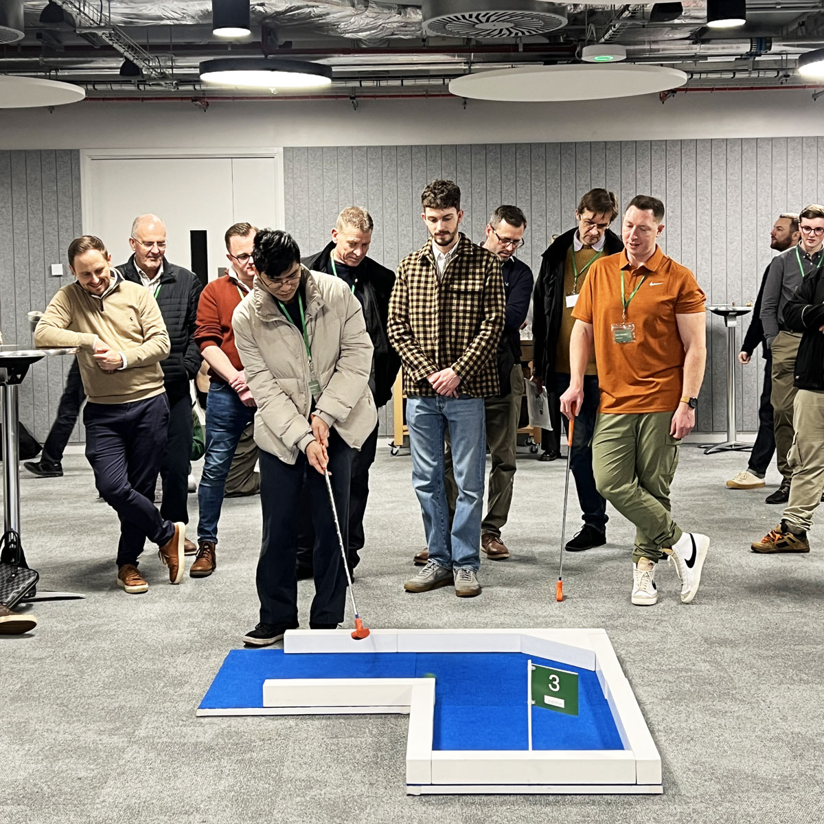 Plant Plan team playing portable mini golf in their office