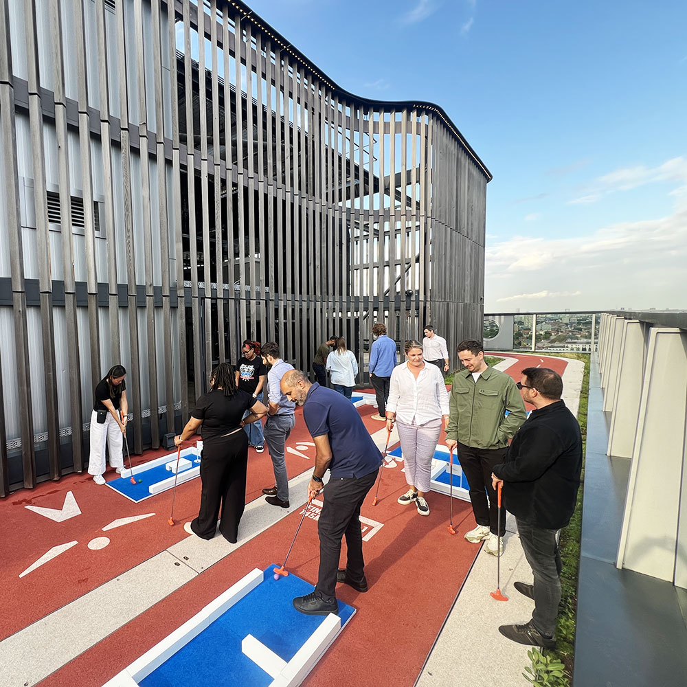 Employees taking part in a workplace mini golf tournament